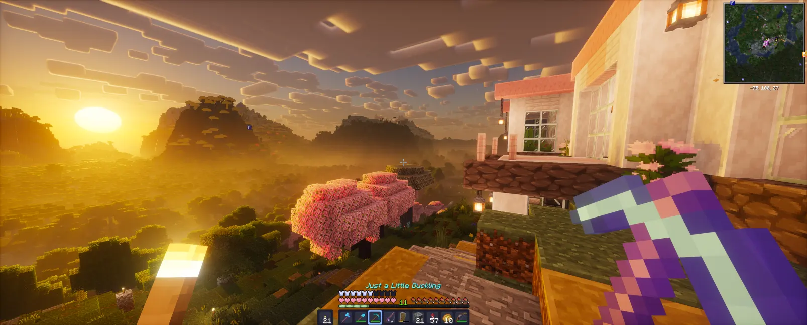 Minecraft screenshot on a widescreen display demonstrating shaders, mods, resource packs and an updated GUI with Distant Horizons enabled.